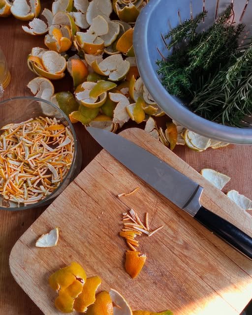 Orange peel being cut on a wooden board